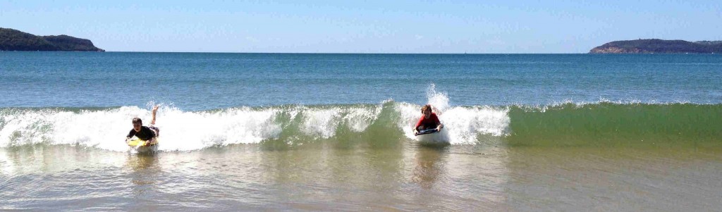 Riding waves at Umina Beach