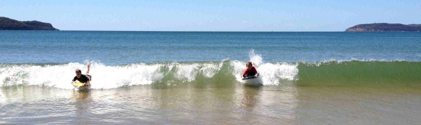 Riding waves at Umina Beach