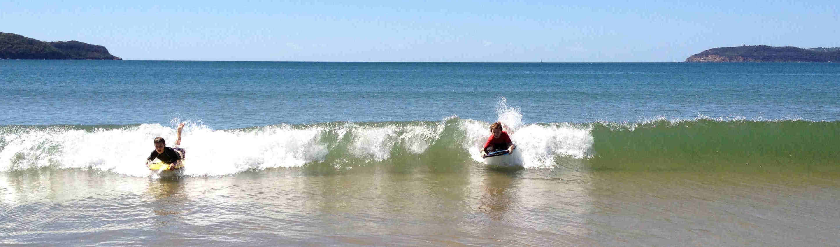 Riding waves at Umina Beach
